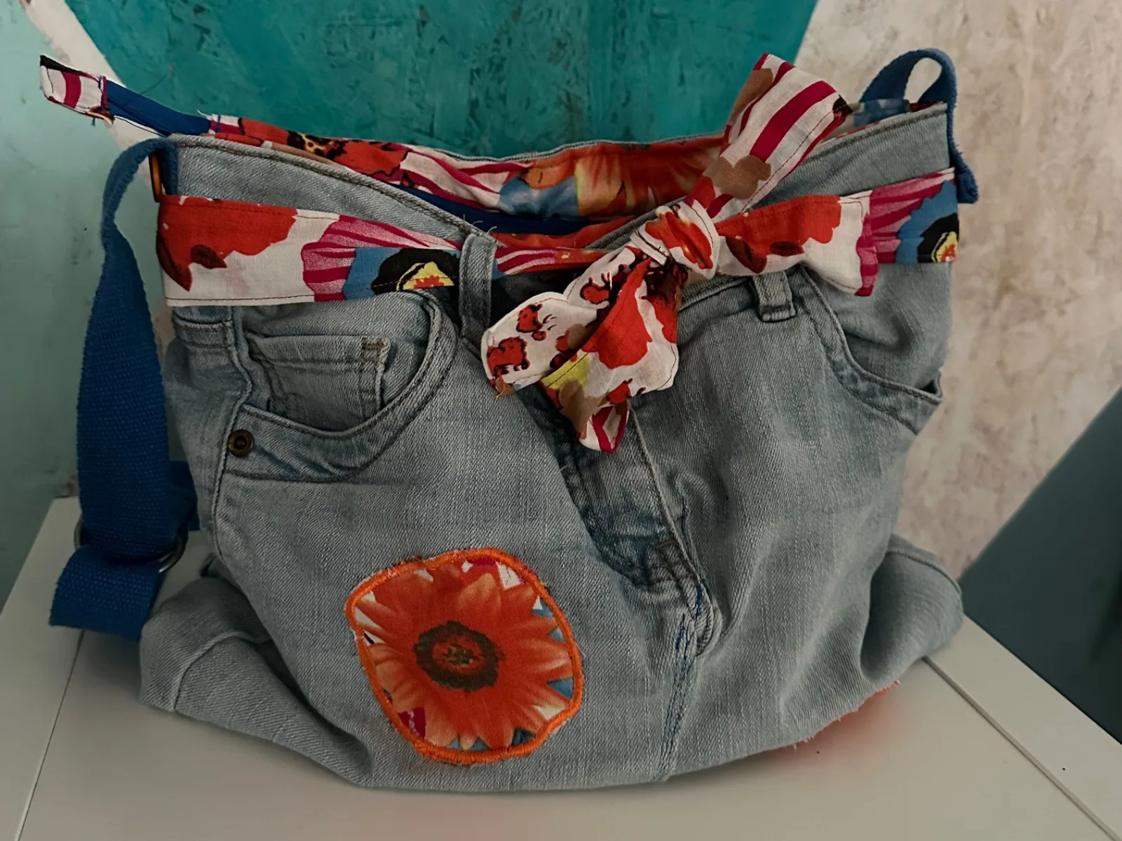 Umhängetasche aus hellblauer Jeans oranger Blumenapplikation